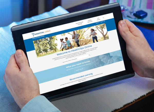 Hands holding a tablet that is displaying HealthClips Online
